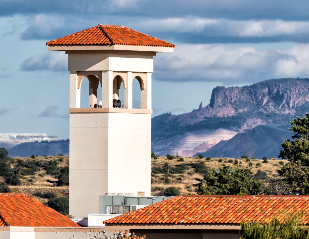 Western New Mexico University bell tower with the Kneeling Nun mountain formation in the background.