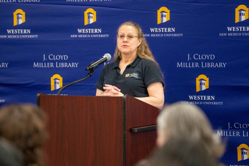 woman standing at WNMU podium