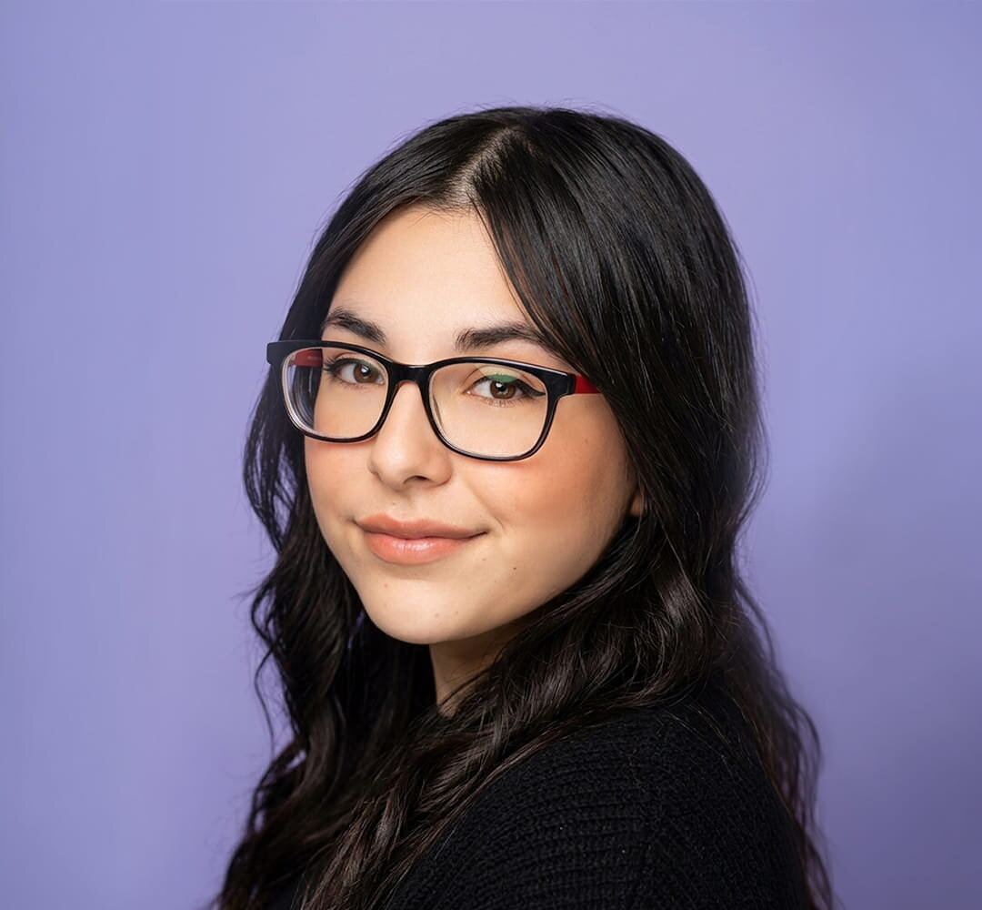 woman with long black hair and glasses