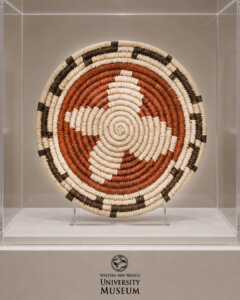 Photo of museum piece, round with orange, black and white weaves
