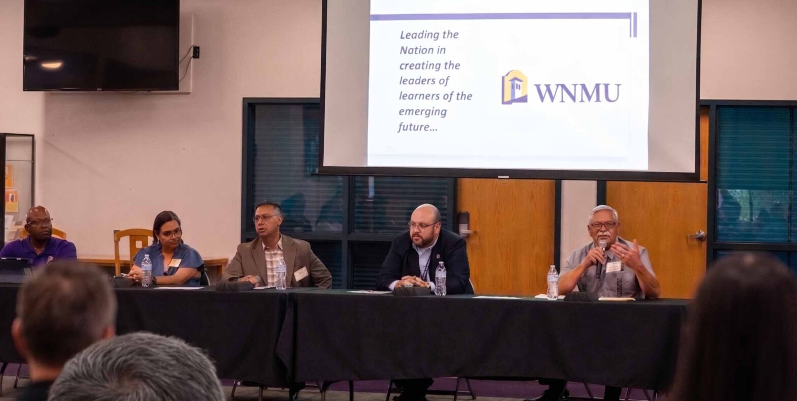 Five people sitting at a panelist table.