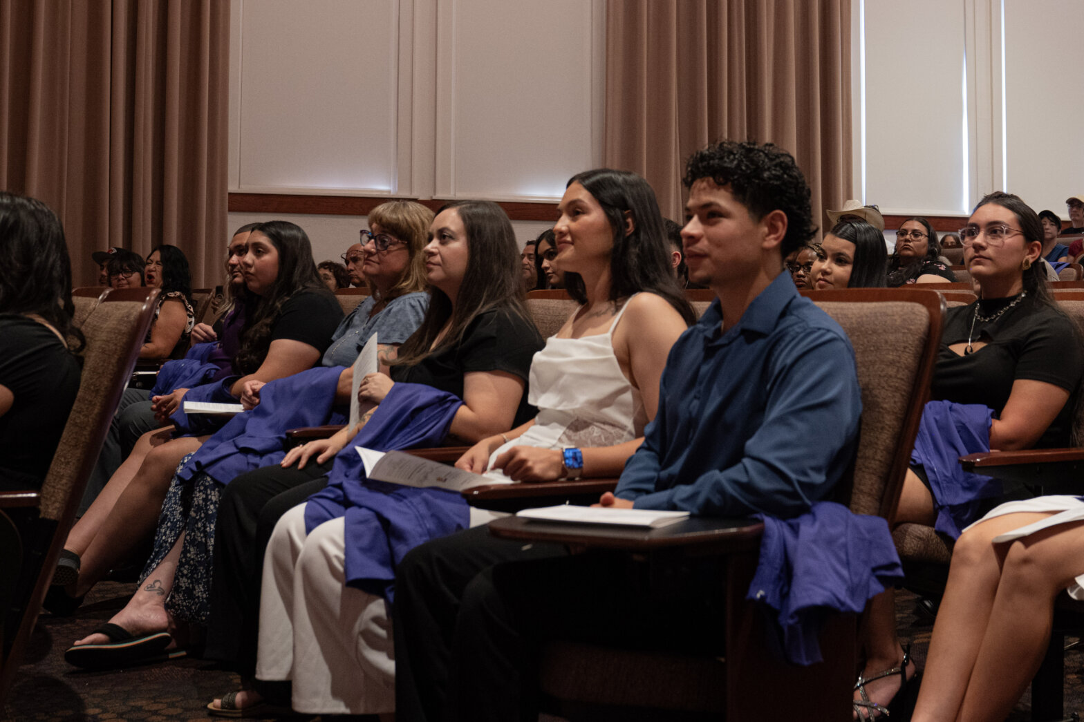 A group of college students in purple nursing coats